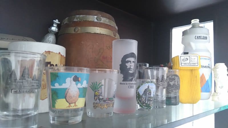 Collection of shot glasses along with other small knick knacks